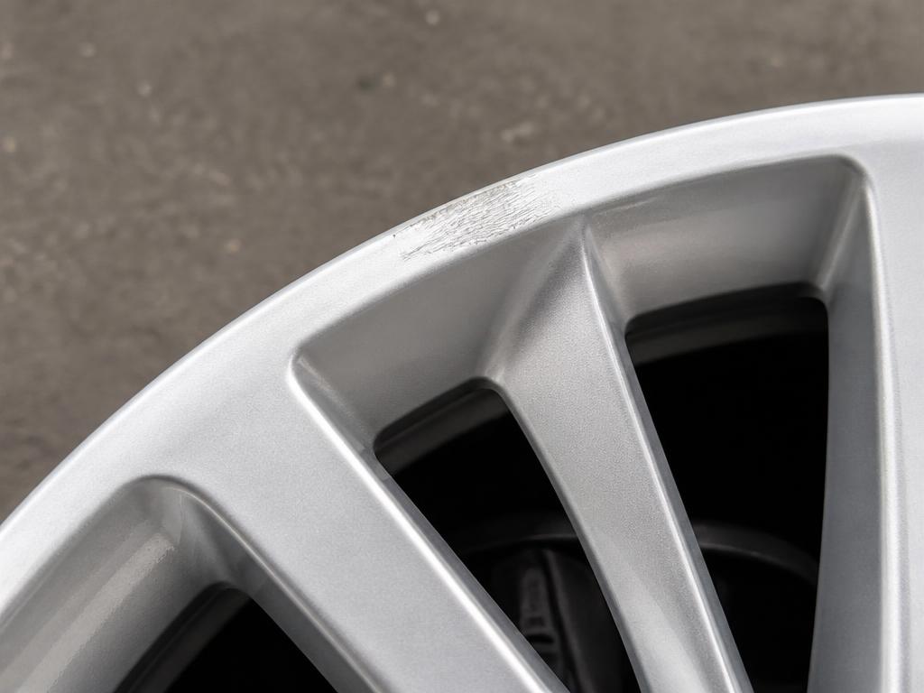 Light surface scratching on a small area of a silver alloy wheel rim